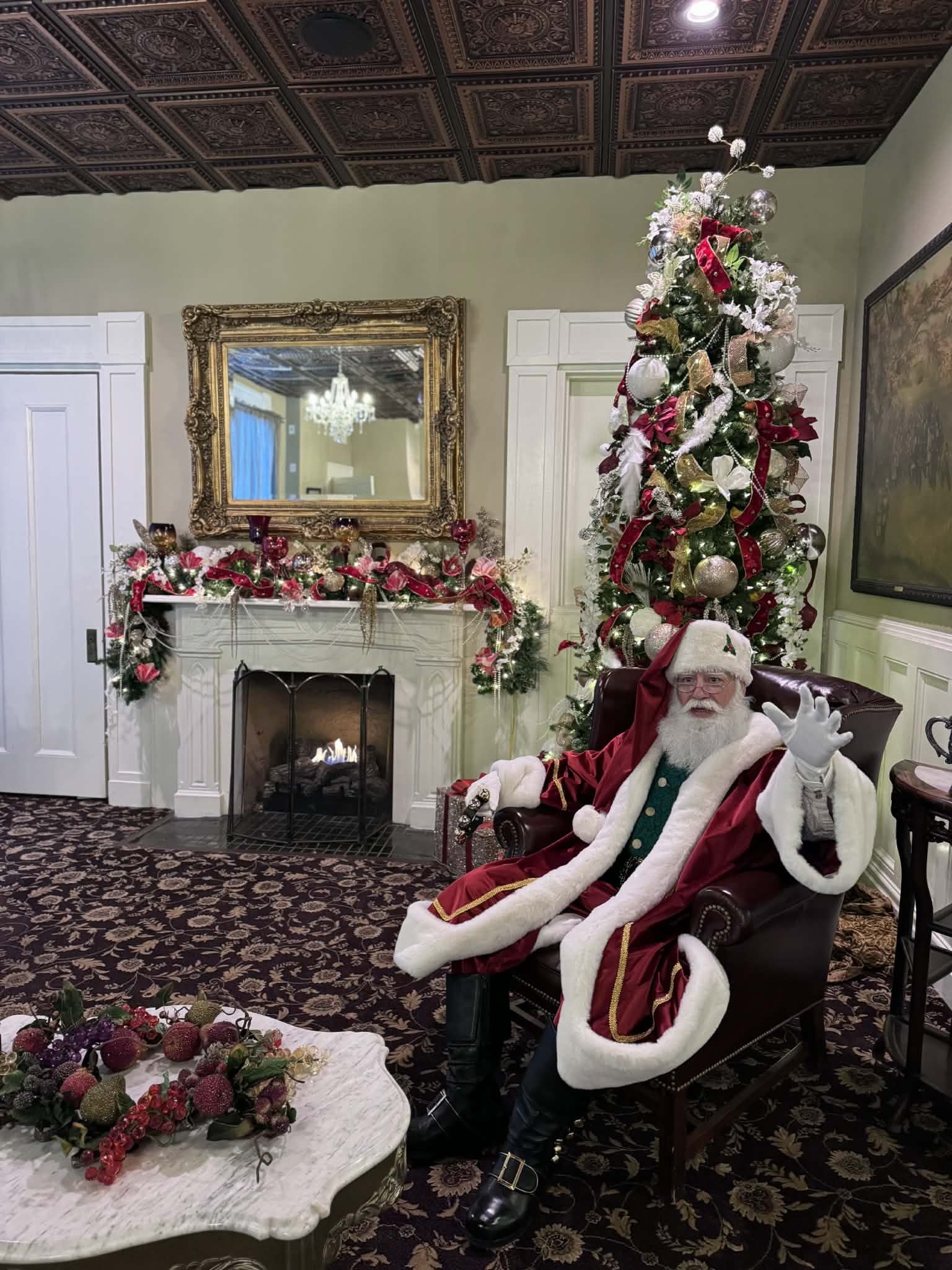 Santa James greeting families in a snow covered evergreen grove